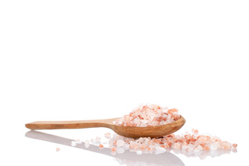 Himalayan salt with a wooden spoon, close-up, isolated on white.
