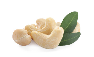 Pile of tasty organic cashew nuts and green leaves isolated on white
