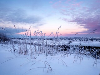 Sunrise over the snow-covered hillside. Winter landscapes