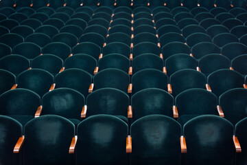 rows of soft velvet armchairs in the theater auditorium