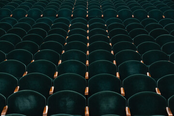 rows of soft velvet armchairs in the theater auditorium