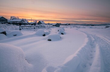 Winter landscape with a trail winding along the village in the snow. winter tourism