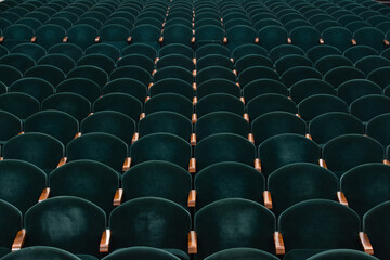 rows of soft velvet armchairs in the theater auditorium