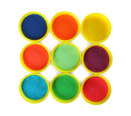 Plastic containers with colorful play dough on white background, top view