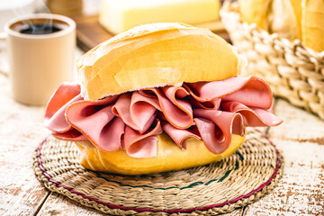 Brazilian bread sandwich with mortadella. Traditional pork snack served in bakeries in Brazil, french bread with bologna - obrazy, fototapety, plakaty