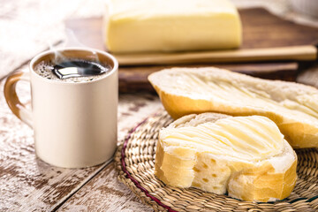 Brazilian bread called French bread, bald or baguette, served with black coffee and butter, a...
