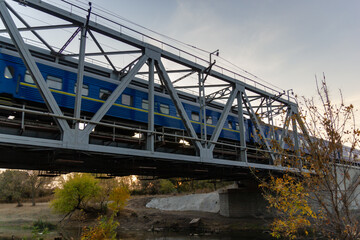 railroad and railway bridge and a passing passenger train