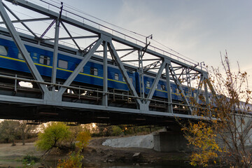 railroad and railway bridge and a passing passenger train