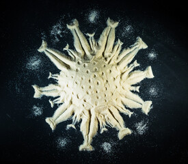 Covid-19 molecula made of white sand with black background