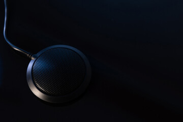 microphone for business conferences on a black background close-up with copy-space