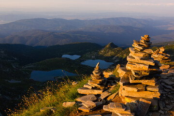 On the top of the mountains, landscape on green mountains and mountain lakes, above the clouds at sunset