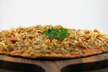 Homemade pizza on a round walnut board