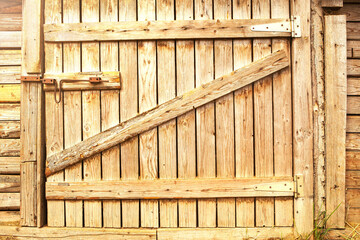 Wooden door to the barn or horse stall, lock on the door.