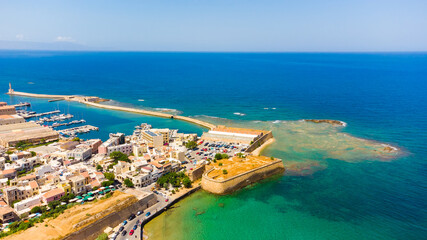 Fototapeta premium Panoramic aerial view from above of the city of Chania, Crete island, Greece. Landmarks of Greece, beautiful venetian town Chania in Crete island. Chania, Crete, Greece.