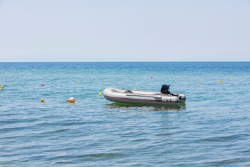 Close up view of water and rubber motor boat on sea coast against backdrop of beautiful nature. Greece.