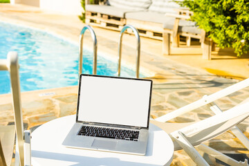 laptop computer on table pool background