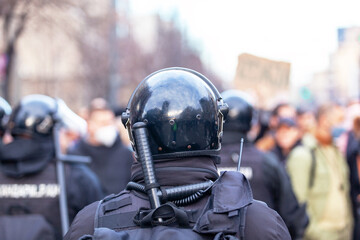 Riot police on duty during crowd protest or demonstration - obrazy, fototapety, plakaty