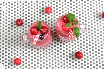 ]Mixed berry smoothie with cranberries. black currants and mint in small circles. View from above. Selective focus