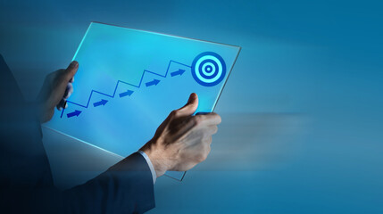 presses the ladder and darts on the tablet. goal achievement concept