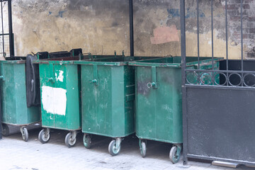 Garbage containers in the courtyard. The reverse side of the old building.