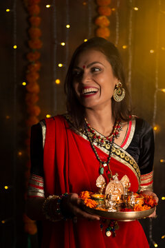 Woman smiling holding pooja plate 