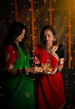Women holding pooja thali 