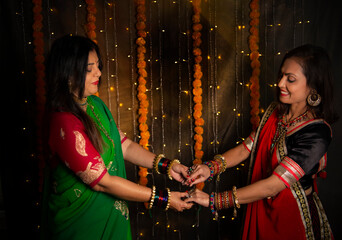 Sisters in Indian wear holding hands 