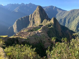 Machu Picchu Inca city in Andes mountains Peru. Ancient ruins of Inca civilization. Majestic landscape Incan citadel at sunny day. Old stone Lost city against mountains.