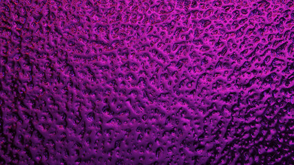 Fototapeta premium Bright purple winter background. The surface of ice frozen on the window pane. An abstract pattern with a metallic sheen, similar to the ripples of mercury. Rich violet wallpaper. Close-up