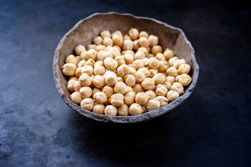 Traditional Indian chickpeas offered as close-up in a rustic design bowl with copy space