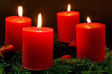 advent wreath with four burning candles