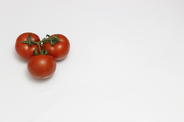 Three tomatoes isolated on white background.