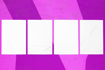 Closeup of geometrical purple and pink painted urban wall texture with four wrinkled glued poster templates. Modern mockup for design presentation. Creative geometric urban city background. 