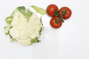Cauliflower and tomatoes isolated on white background. top view