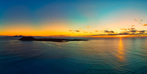 Fototapeta na wymiar Panoramic view of the sunrise over Isla de Lobos island Fuerteventura
