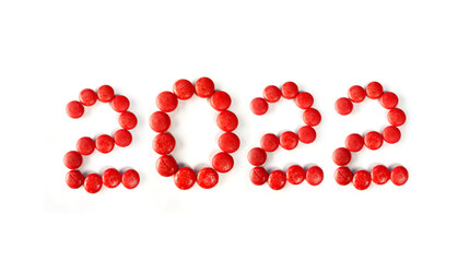 2022 concept with red wooden ball or round object. writing 2022 on white paper