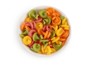 Raw colored pasta in ceramic bowl isolated on white background with clipping path and full depth of field. Top view. Flat lay