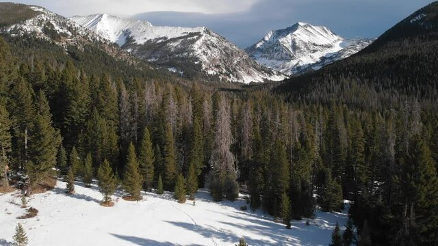 rise up to dramatic snow covered mountains in the Crazy Mountains 