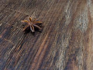 Anise star on a wooden background with a beautiful texture