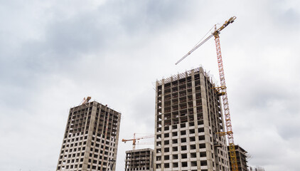Fototapeta na wymiar Construction of a multi-storey building. A high-rise crane on the construction of a multi-storey building.