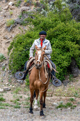 Neuquen, Argentina, November 21, 2021; Argentine cowboy (gaucho) walks his horse past camera, in...