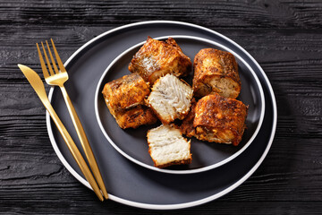 fried pieces of hake on a plate