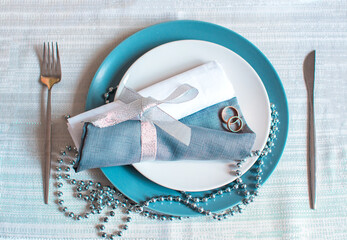 Beautiful table setting. Wedding rings  on the plates