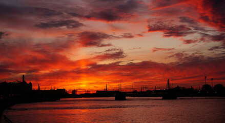 Fototapeta na wymiar bridge over the Neva River in St. Petersburg on the background of an orange sunset