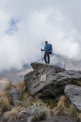 Obraz premium Woman hiker on a top of a mountain