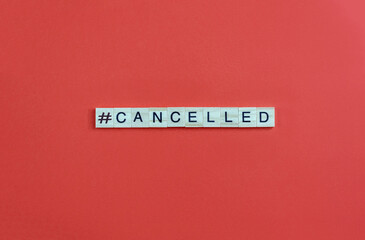 Word Сanceled and hashtag sign on wood bloks with lettering on red background. Cancel culture...