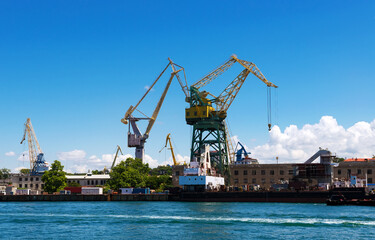 Fototapeta na wymiar Cargo crane, freight traine and coal in port
