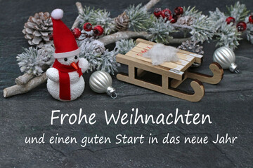 Weihnachtskarte:Schneemann mit Schlitten und Weihnachtsgruß,frohe Weihnachten.