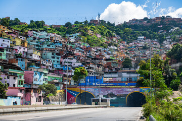 Caracas, Venezuela, 11.27.2021: view of the urban highway at the height of the tunnel "El Valle" with a popular suburb located on a hill.