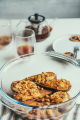 Baked Pears dessert with soft cheese. cinnamon, honey and nuts in the baking form. Delicious autumn dessert. Vertical card. Selective focus, copy space